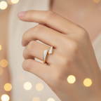 Gold and white stone bypass open cuff ring worn on finger with warm golden bokeh