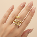 Gold Serpent Coil Wrap Open Ring - worn on finger cream background lifestyle shot
