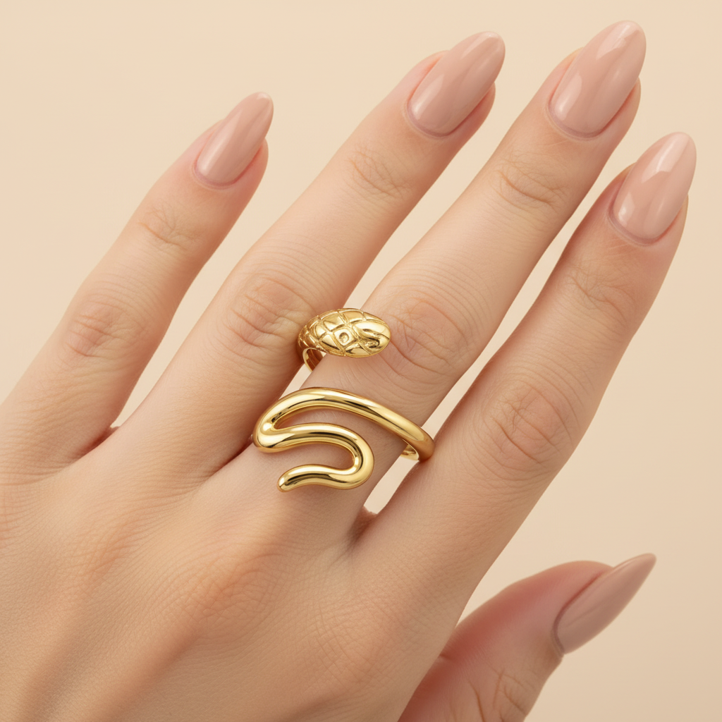 Gold Serpent Coil Wrap Open Ring - worn on finger cream background lifestyle shot