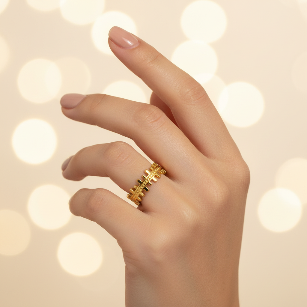 Gold crown battlements open band ring worn on woman's finger