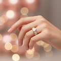 Gold white enamel heart band open cuff ring worn on finger with romantic bokeh