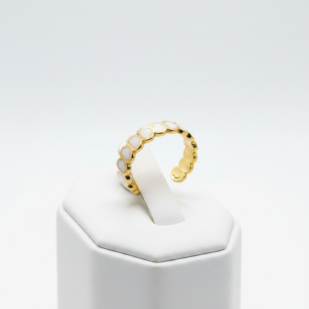 Gold white oval enamel wide band open cuff ring on white jewelry stand, clean studio shot