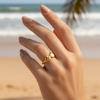 Gold triple seashell open band ring worn on woman's finger
