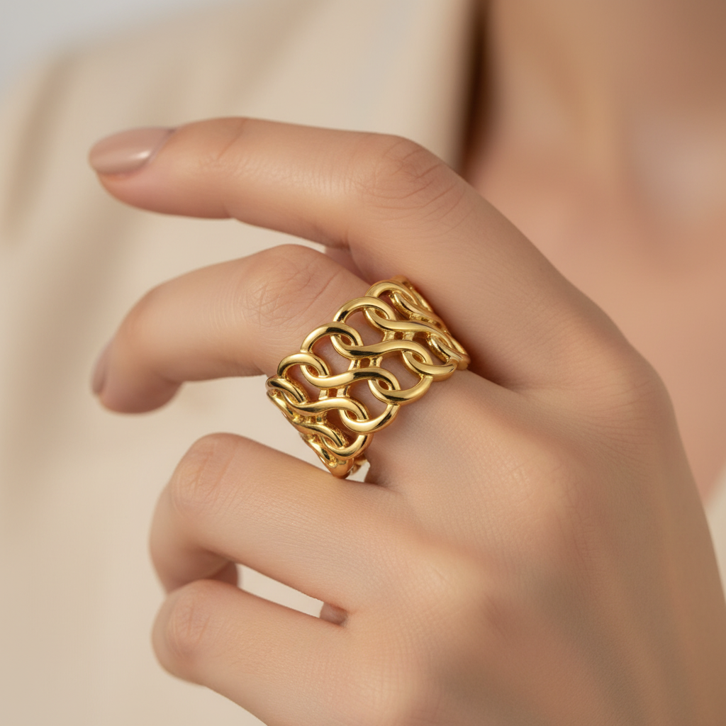Gold Interlocking Wave Chain Wide Cuff Open Ring - worn on finger cream background lifestyle shot