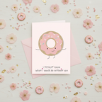 Flat lay composition of donut greeting card with envelope and sweet decorative elements