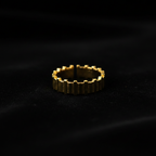 Gold vertical bar link wide band open cuff ring on black velvet with dramatic rim lighting