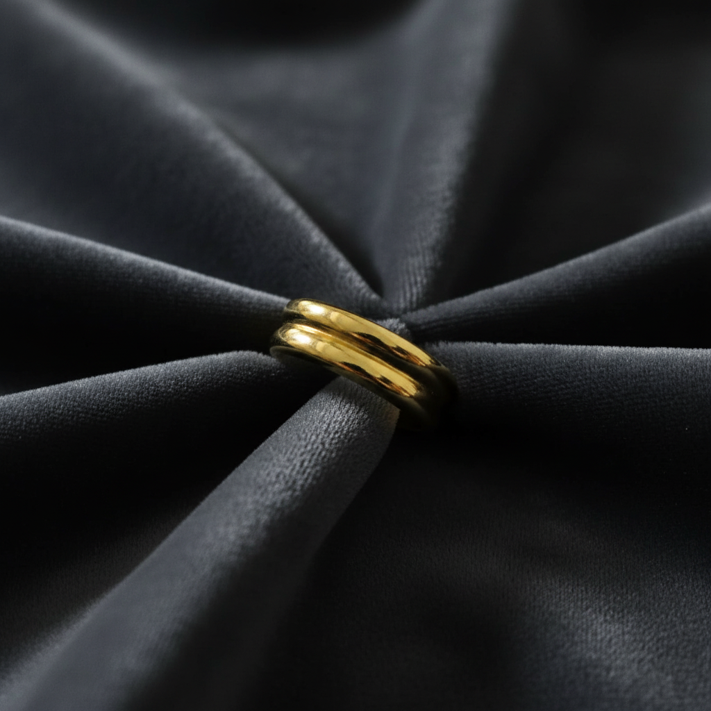 Gold double layer ring on charcoal grey velvet fabric