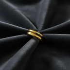 Gold double layer ring on charcoal grey velvet fabric