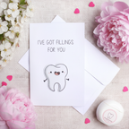 Flat lay composition of tooth greeting card with envelope and Valentine's Day decorative elements