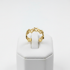 Gold linked star cutout band open cuff ring on white jewelry stand, clean studio shot
