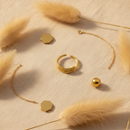 Gold double layer ring flat lay with pampas grass and gold accents on ivory linen