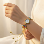 Multicolor gem bracelet watch on ivory background