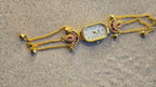 Peacock Charm Bracelet Watch Gold Plated with ruby stone accents and bell charms