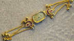 Peacock Charm Bracelet Watch Ruby Edition – front view